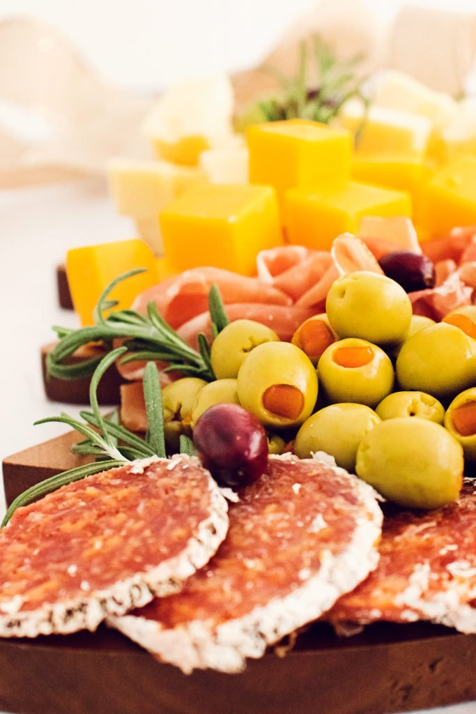 slices of salami, olives and cheese on platter