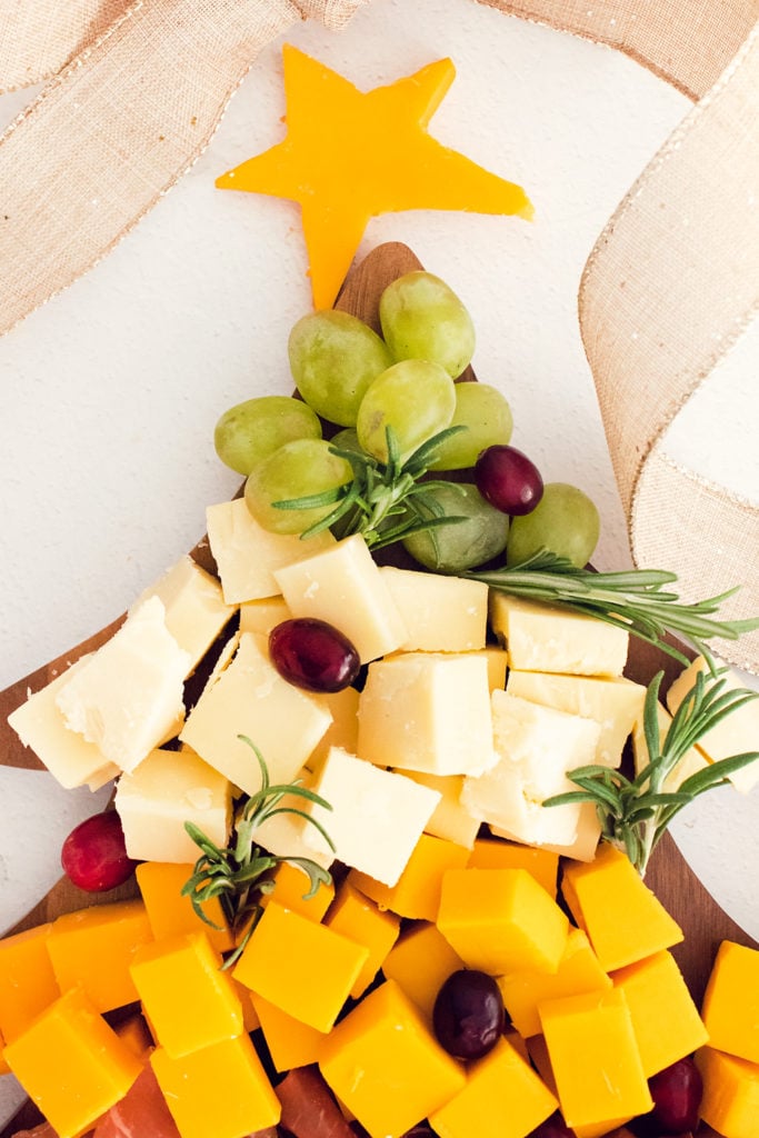 cubes of cheese and grapes on Christmas tree platter
