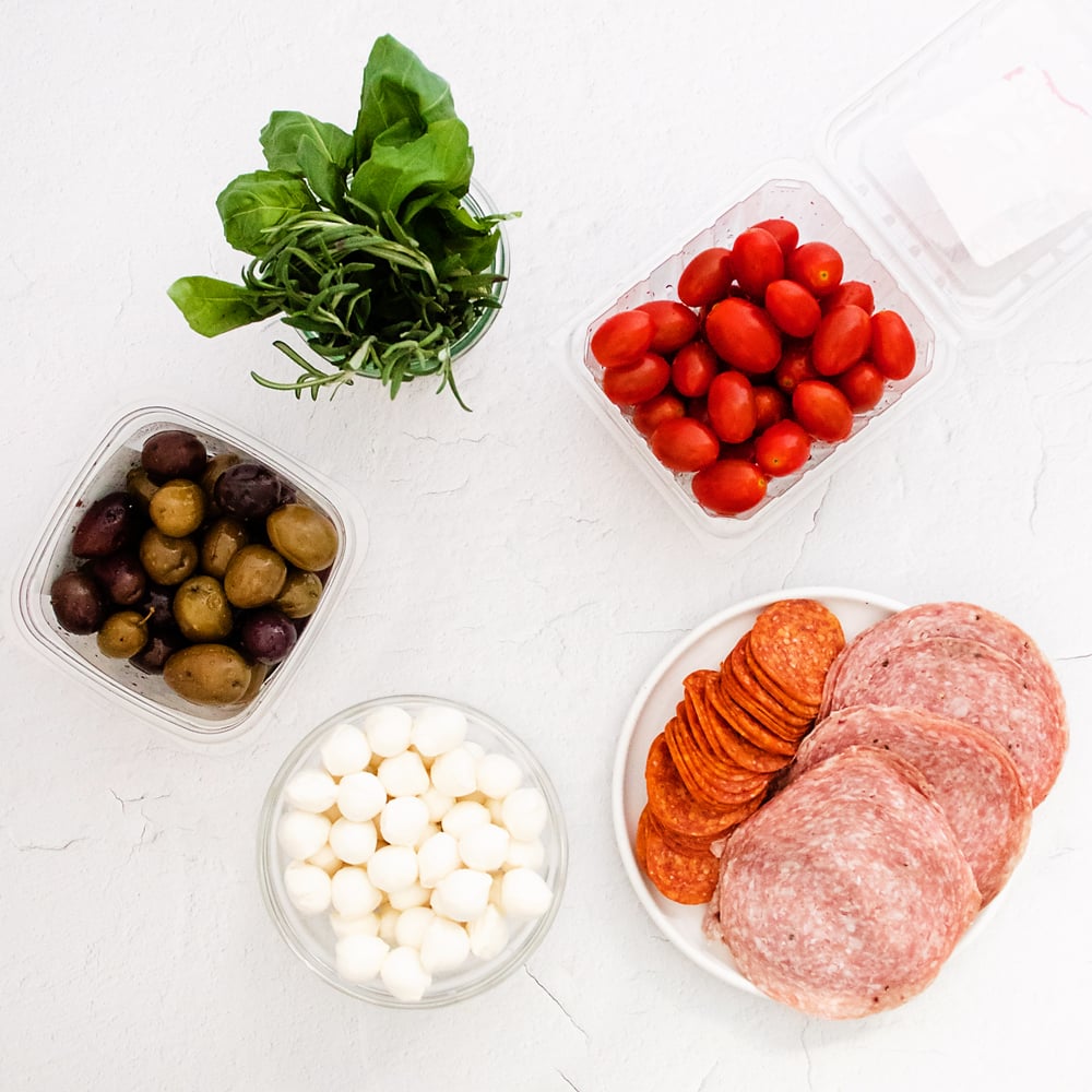 antipasto ingredients on white table