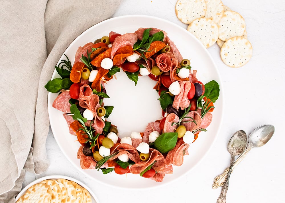 antipasto wreath on white plate with napkin and crackers