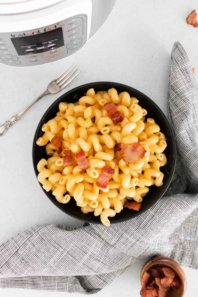 Bacon Mac and Cheese on table with napkin and Instant Pot