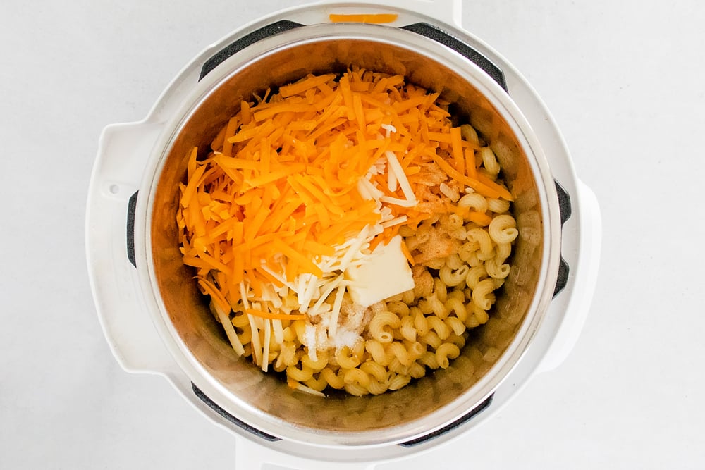 Pasta, cheese and butter in Instant Pot for Bacon Mac and Cheese