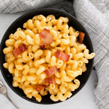 Pressure Cooker Bacon Mac and Cheese on table with grey napkin
