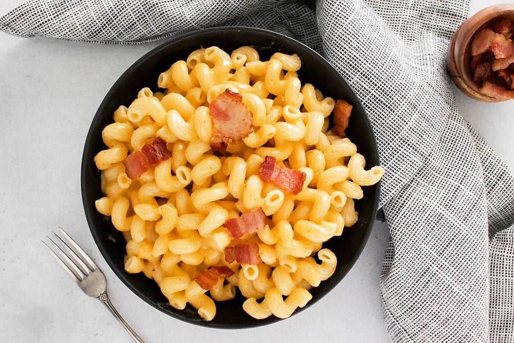 Pressure Cooker Bacon Mac and Cheese on table with grey napkin