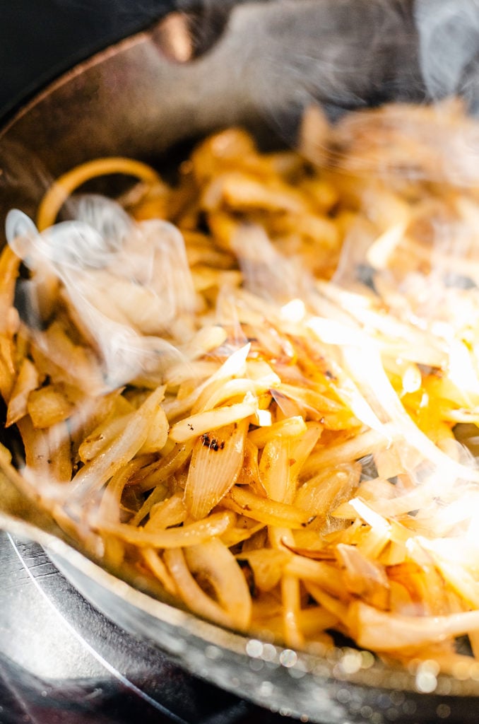 black cast iron pan with caramelized onions