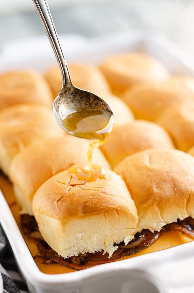 savory butter sauce poured on Hawaiian roll turkey sliders