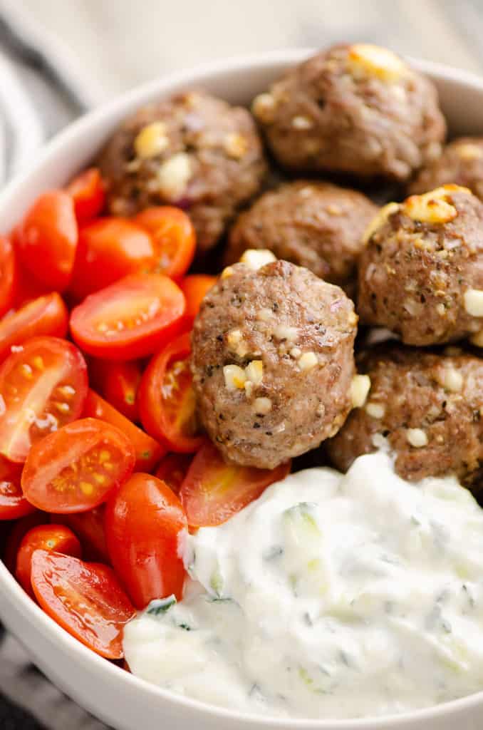 Greek meatball bowls with tomatoes and yogurt sauce