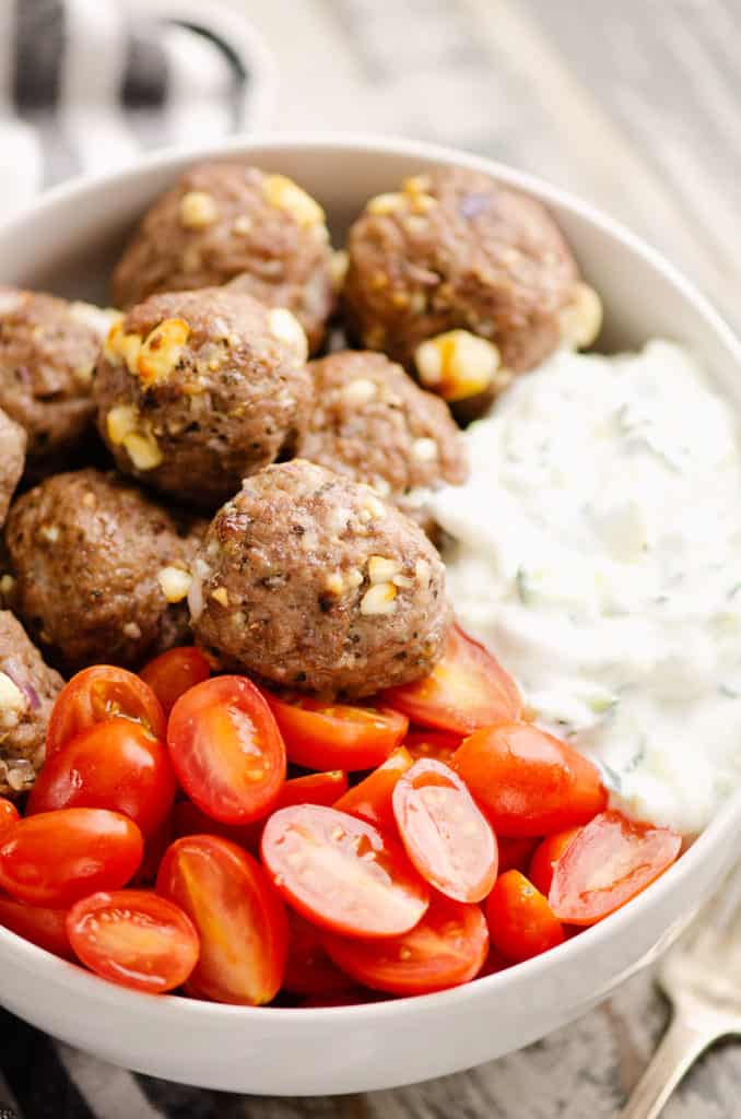 Greek meatball bowls with tomatoes and yogurt sauce