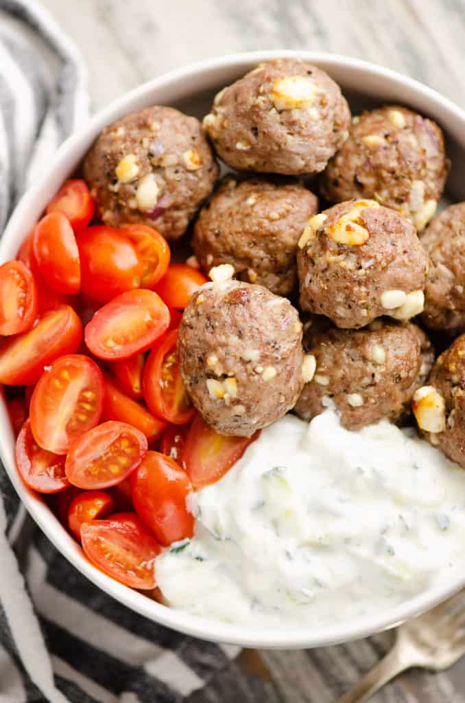 Greek meatball bowls with tomatoes and yogurt sauce