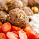 Greek meatball bowls with tomatoes and yogurt sauce