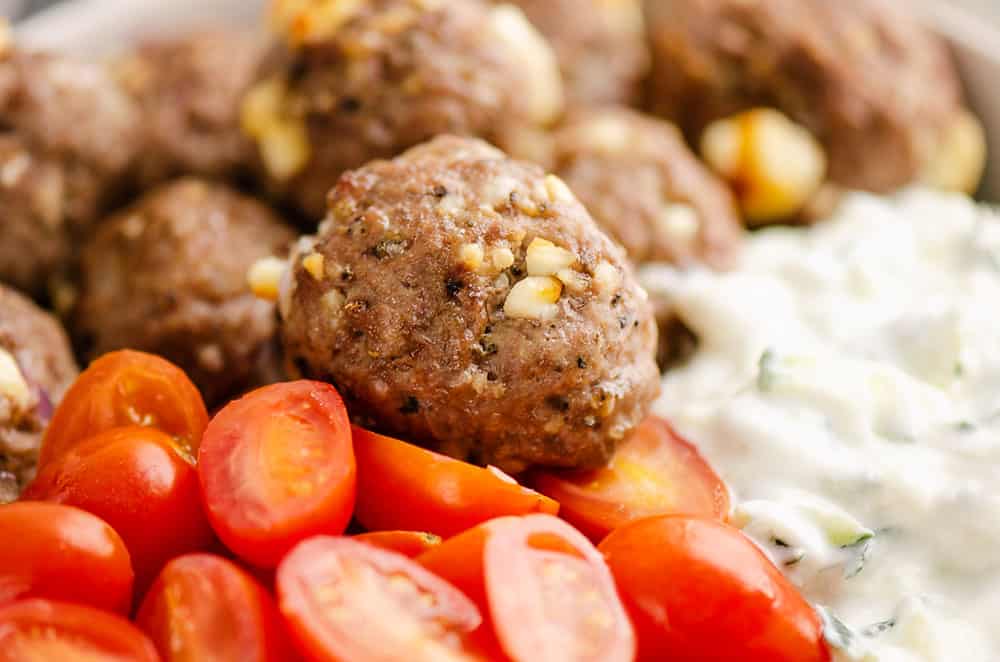 Greek meatball bowls with tomatoes and yogurt sauce