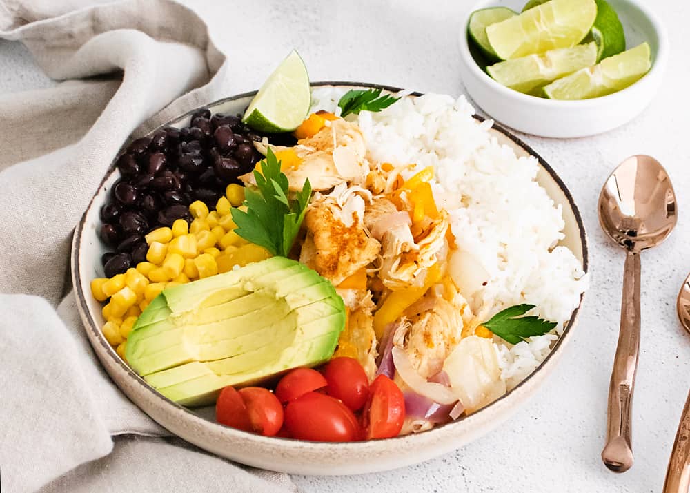 pressure cooker chicken fajita bowls on table with napkin and spoons