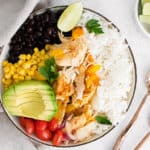 pressure cooker chicken fajita bowls on table with spoons and lime wedges