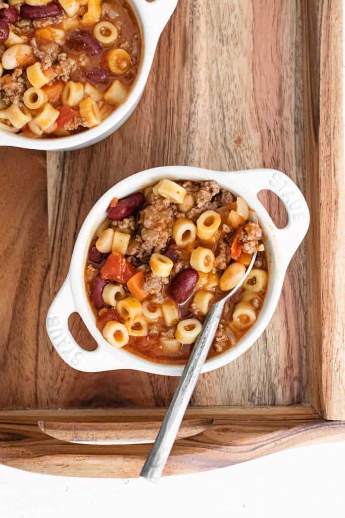 white bowls on wood tray with pasta e fagioli soup