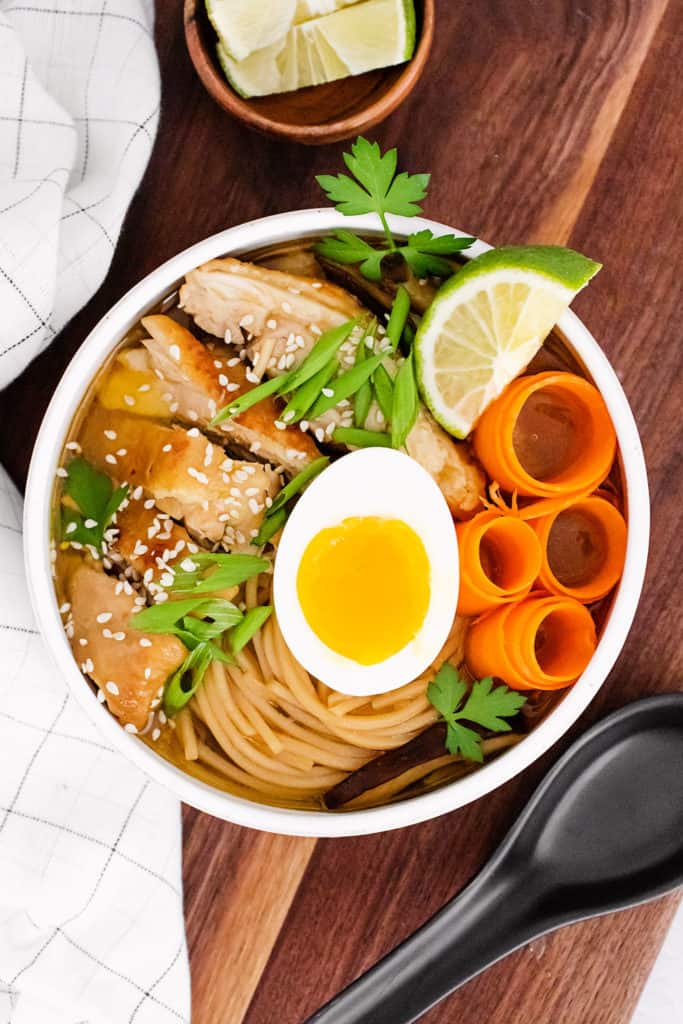 Chicken Ramen with Sweet Chili Oil served in bowl with lime wedge