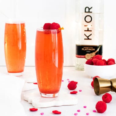 Raspberry Rosé Spritzer on table with bottle of vodka