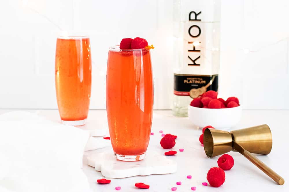 Raspberry Rosé Spritzer on table with bottle of vodka