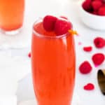 Raspberry Rosé Spritzer topped with raspberries on toothpick