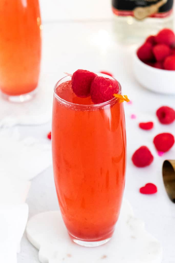 Raspberry Rosé Spritzer topped with raspberries on toothpick