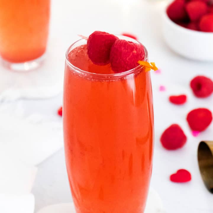 Raspberry Rosé Spritzer topped with raspberries on toothpick