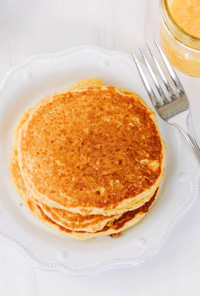 stack of cornmeal pancakes on white plate