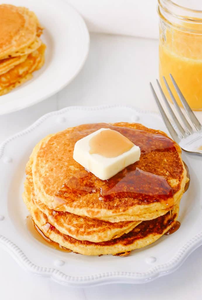 cornmeal pancakes topped with butter and syrup