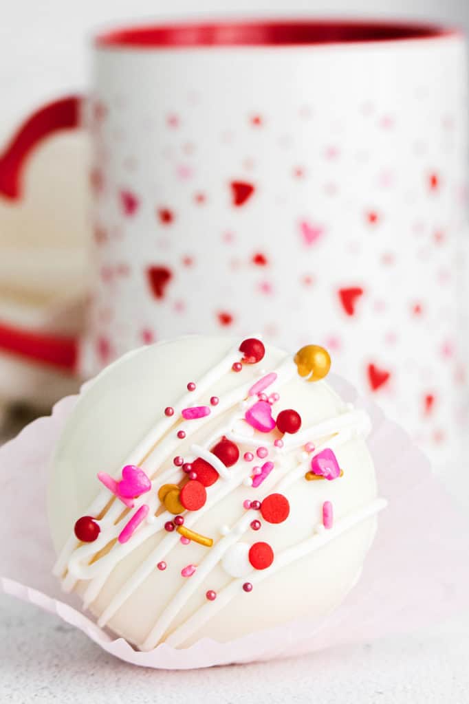 white chocolate hot cocoa bomb with heart sprinkles