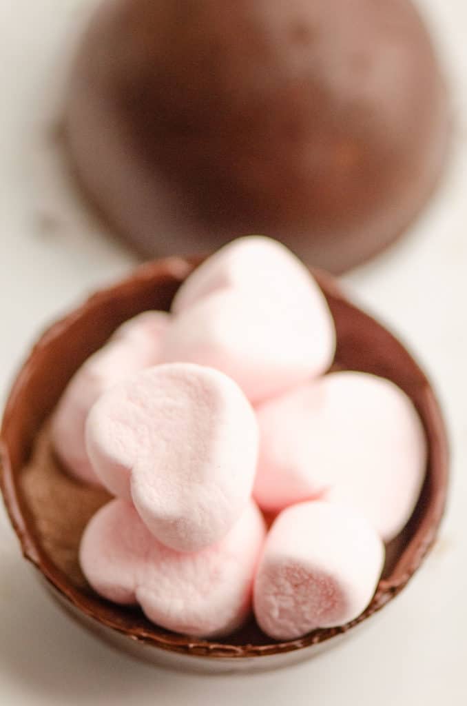 hot cocoa bomb with pink marshmallows inside