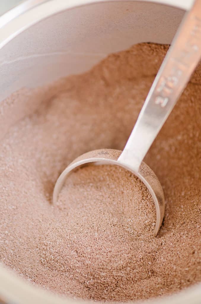 hot cocoa mix in container with tablespoon