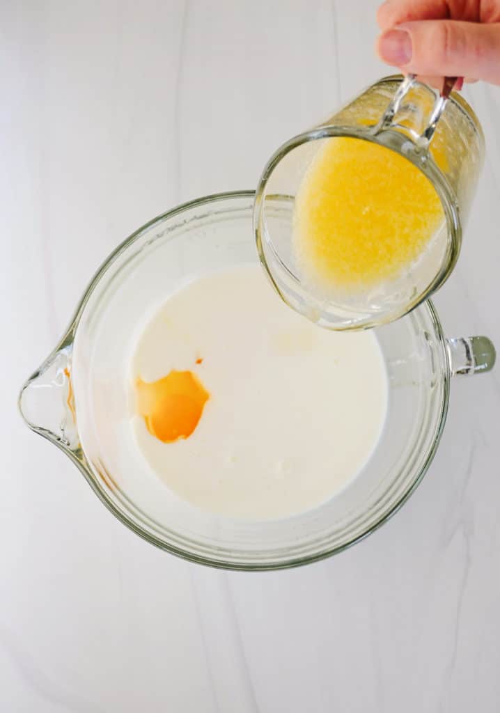 melted butter being poured into eggs and buttermilk