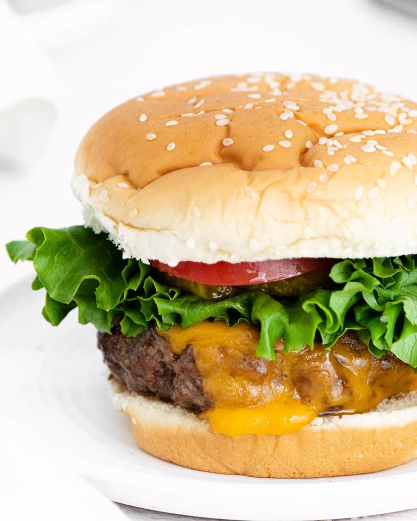 air fryer cheeseburger on white table