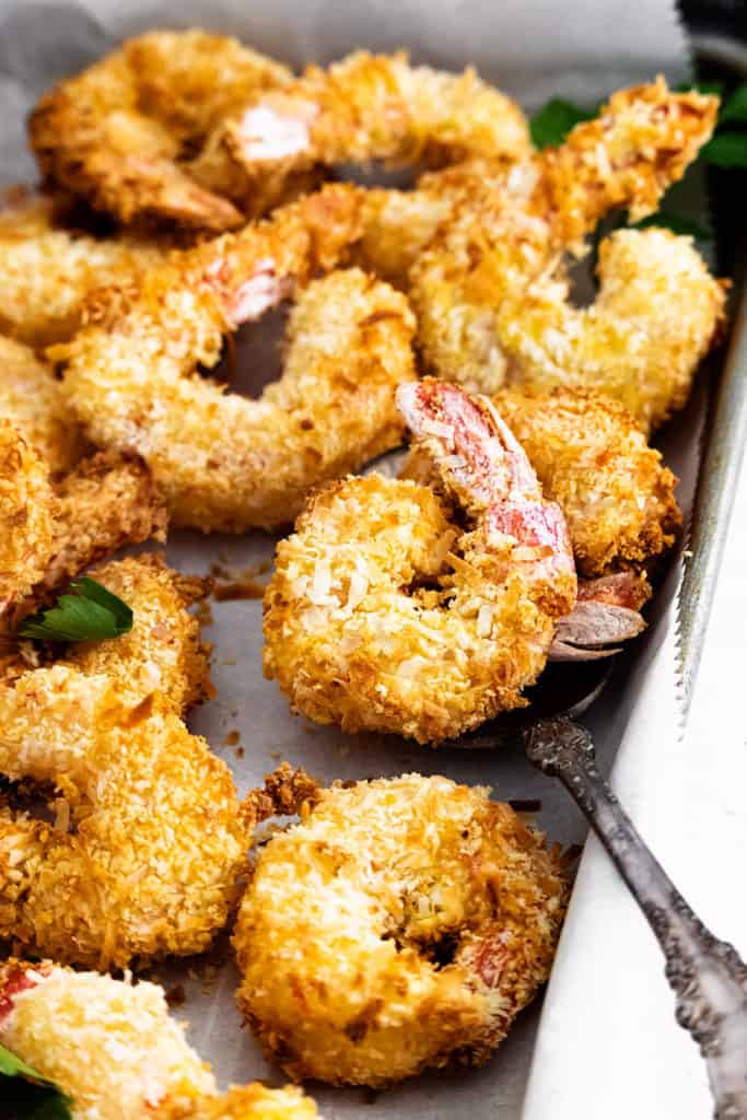 coconut shrimp on sheet pan with spoon