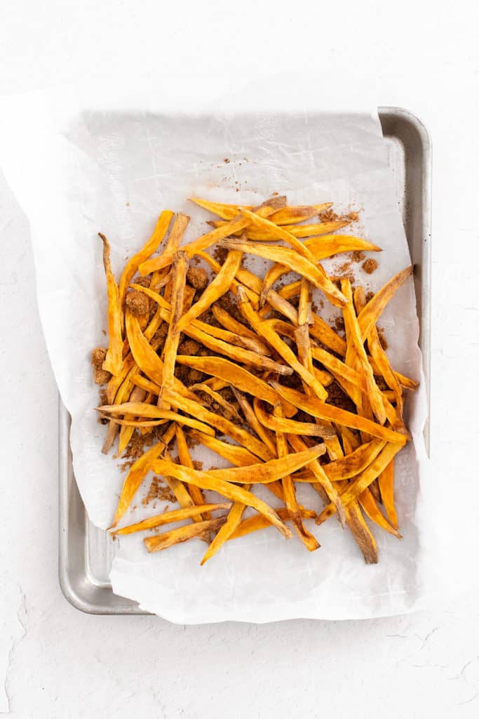 sweet potato fries on sheet pan with parchment