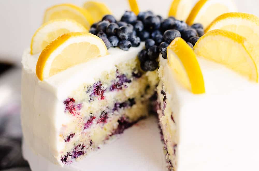 buttercream cake with blueberry layers with slice removed