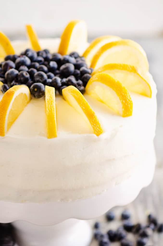 buttercream cake topped with fresh blueberries and lemon slices