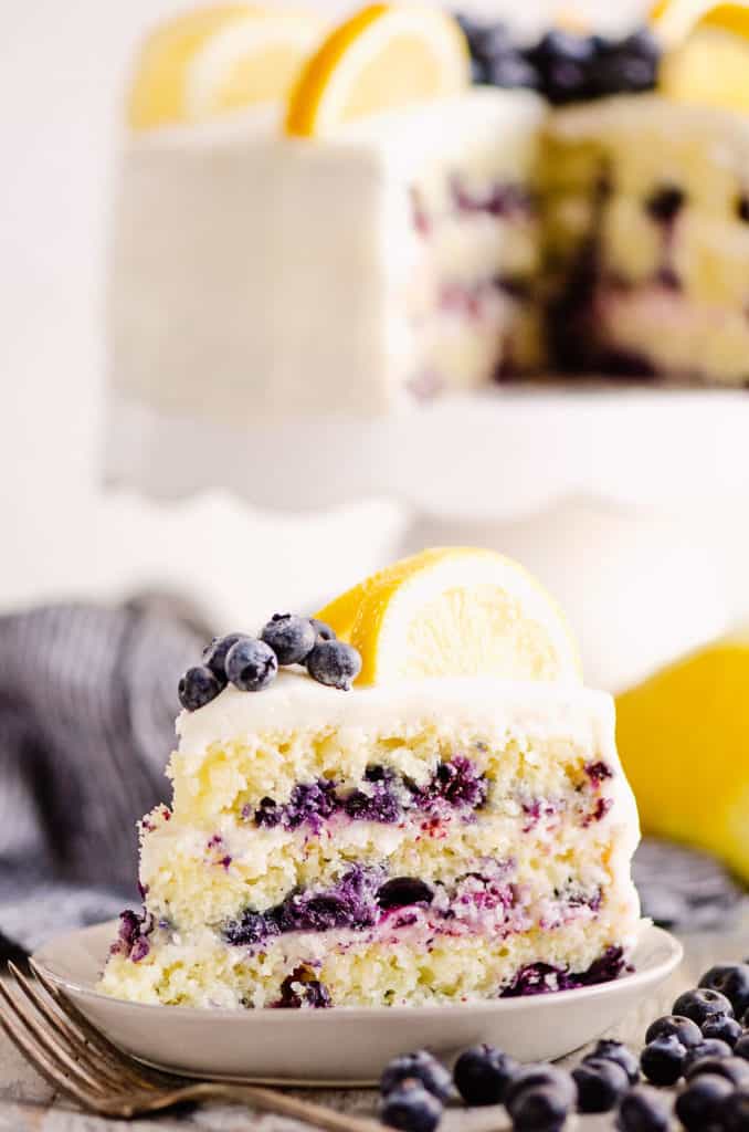 slice of layered blueberry lemon cake on plate