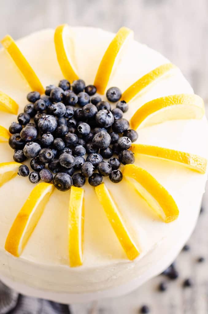 buttercream cake topped with lemon slices and blueberries