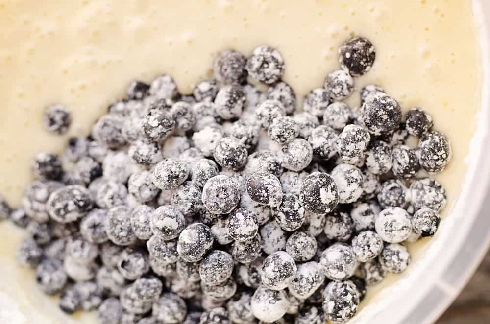 floured blueberries in cake batter bowel