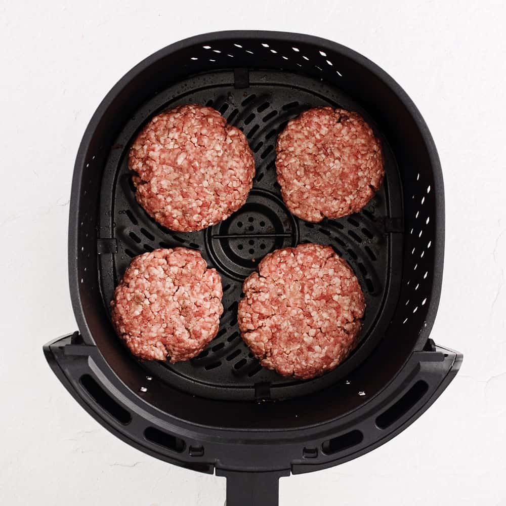 raw burgers in air fryer basket