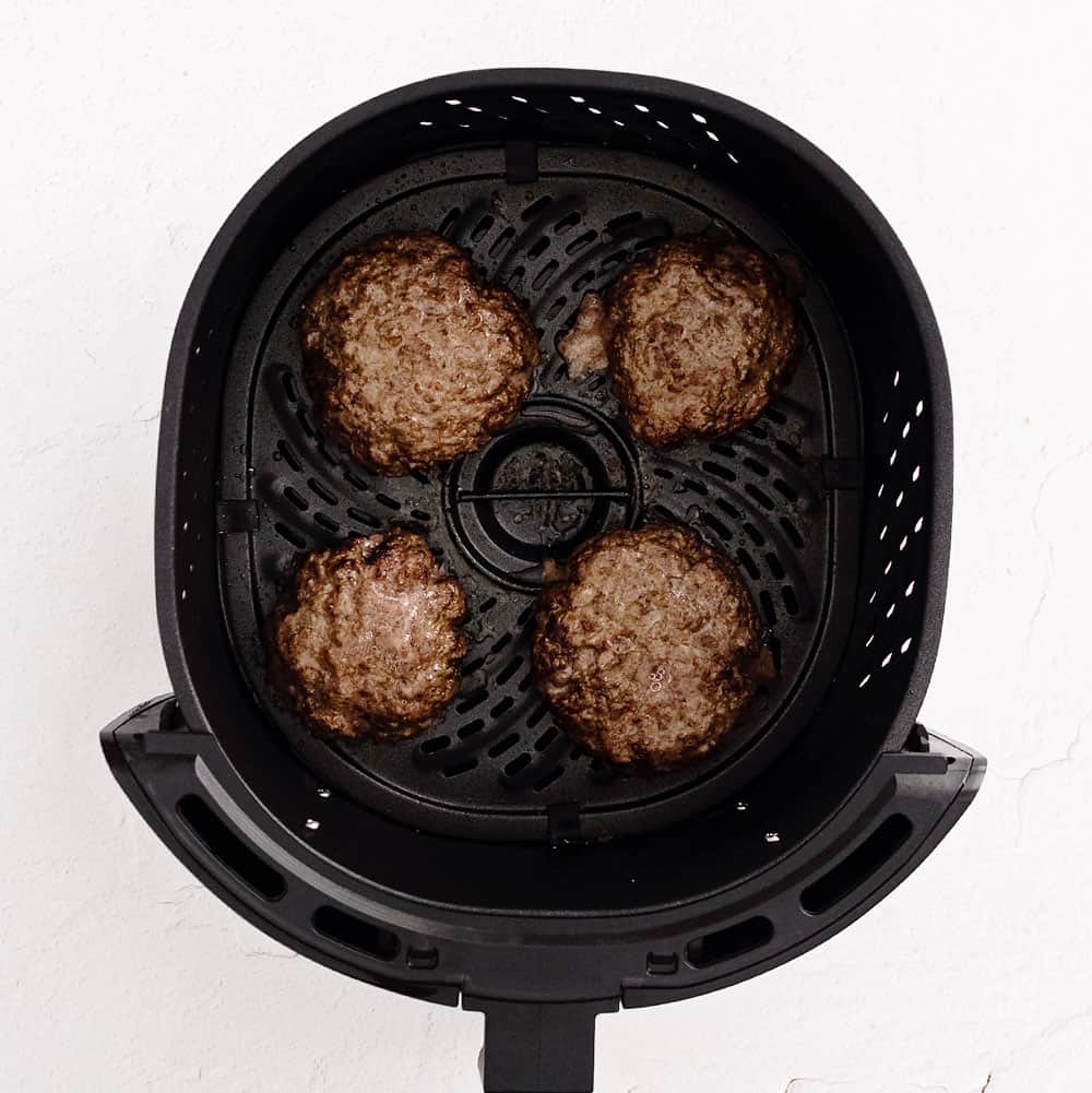 cooked hamburgers in air fryer basket