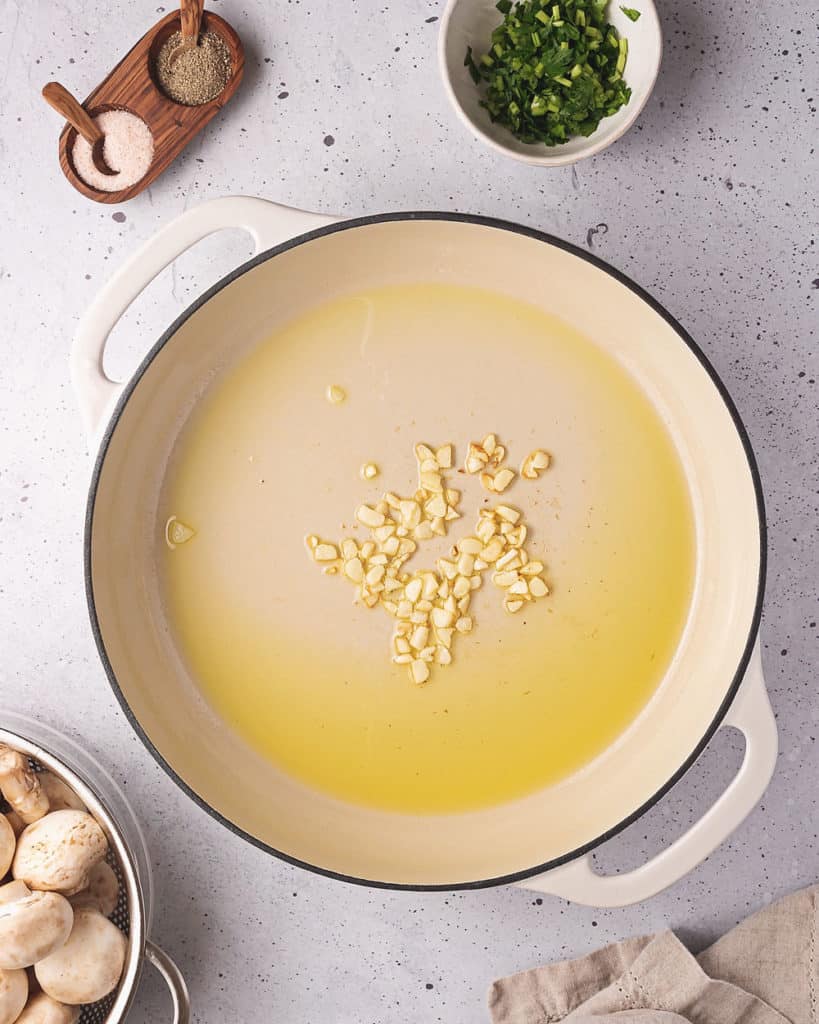 diced garlic in large pot sauteeing in olive oil