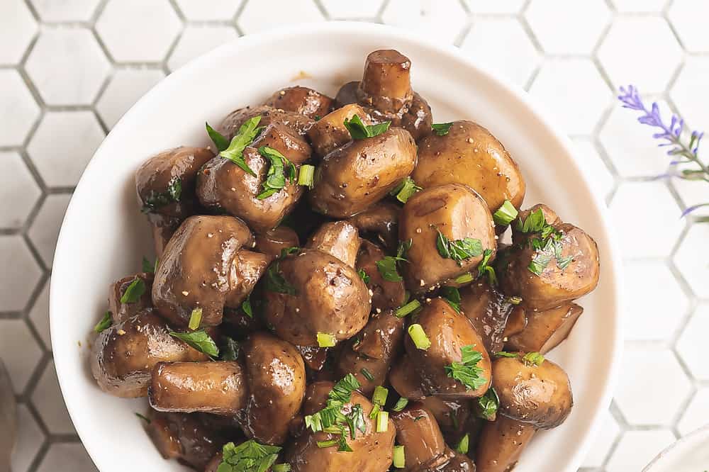 sauteed mushrooms in bowl on tile counter