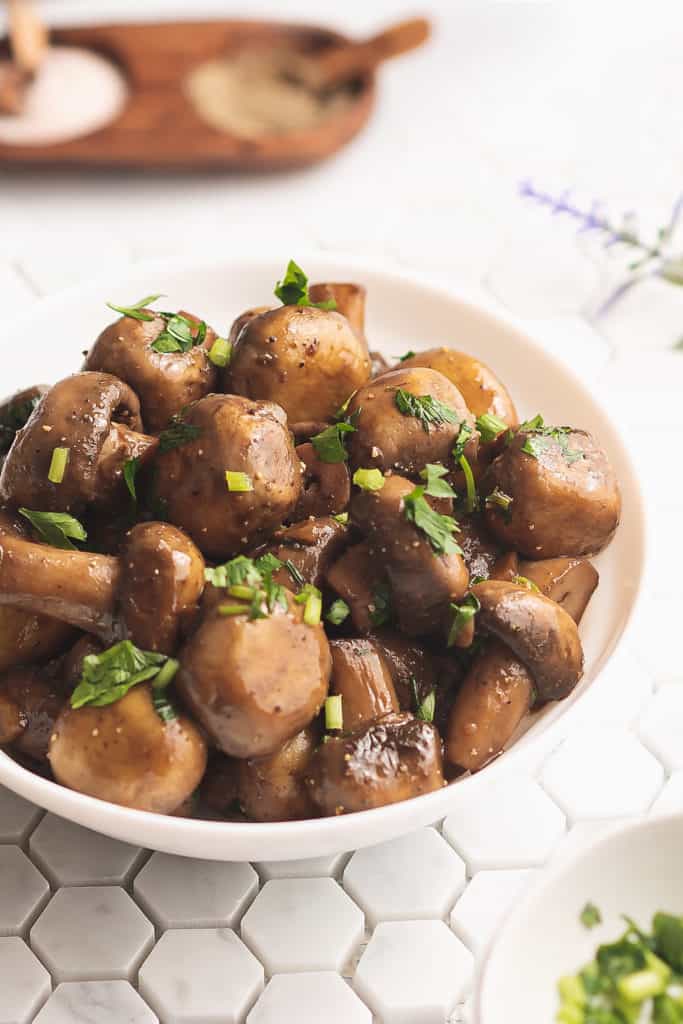 sauteed mushrooms in bowl on tile table