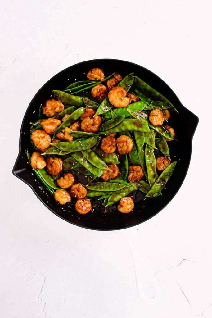 sesame shrimp and peas in cast iron skillet