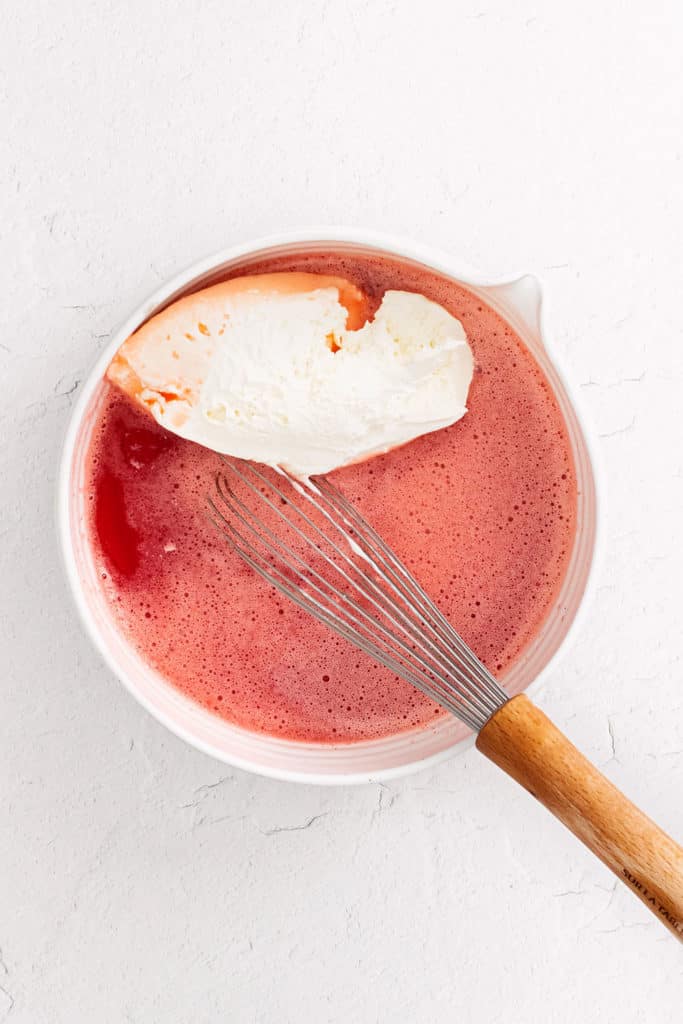 strawberry jello in bowl with cool whip