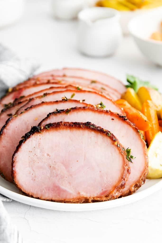 sliced garlic herb ham on serving with vegetables