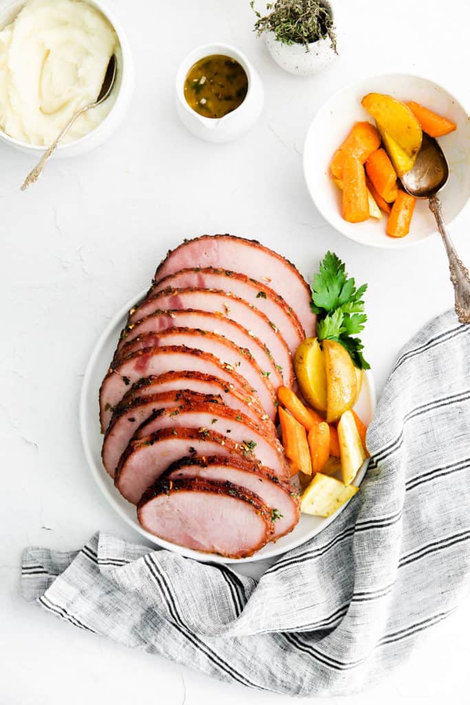 tablescape with platter of air fryer ham, vegetables and potatoes