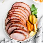 white tray with sliced ham and vegetables