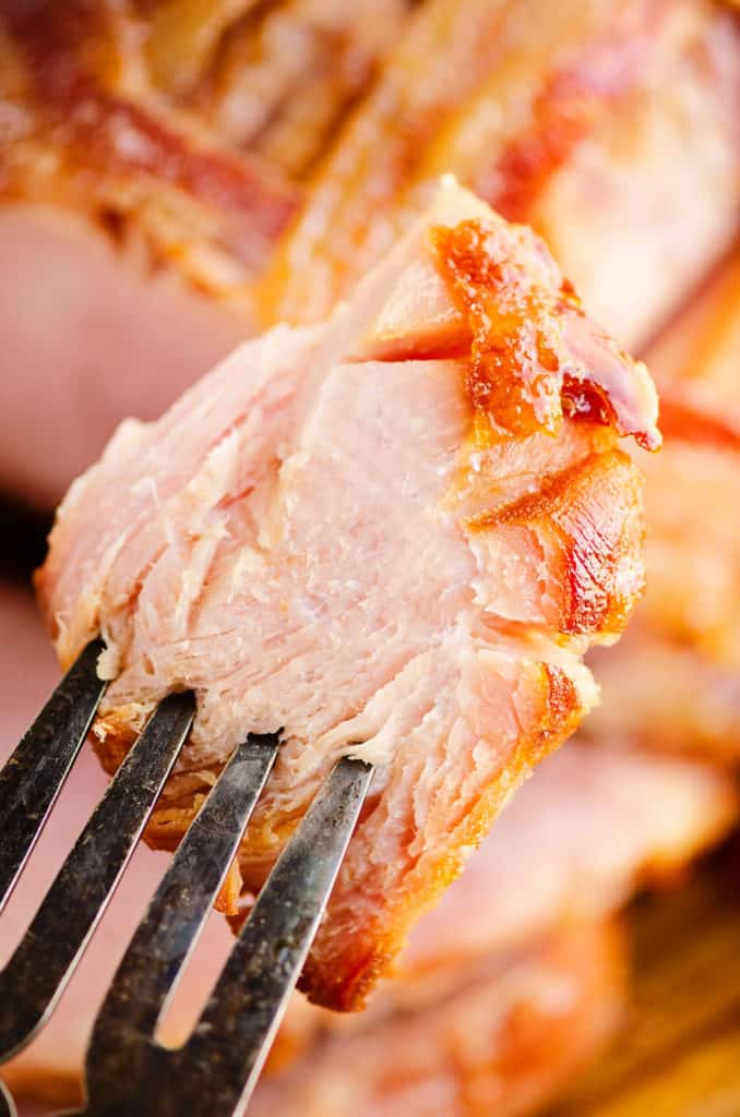 piece of glazed ham on serving fork