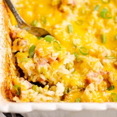 cheesy ham casserole with spoon scooping out ingredients